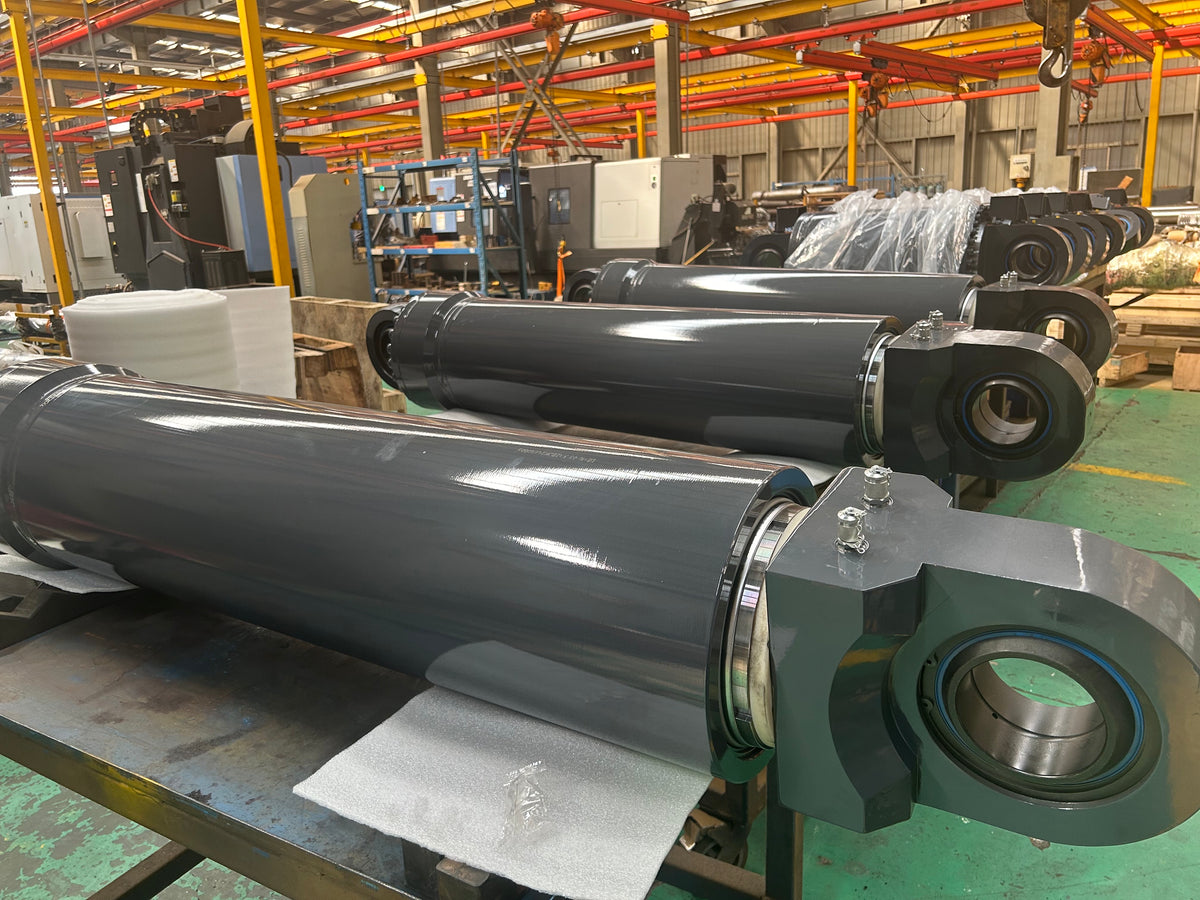 Finished large excavator hydraulic cylinder assemblies in production workshop